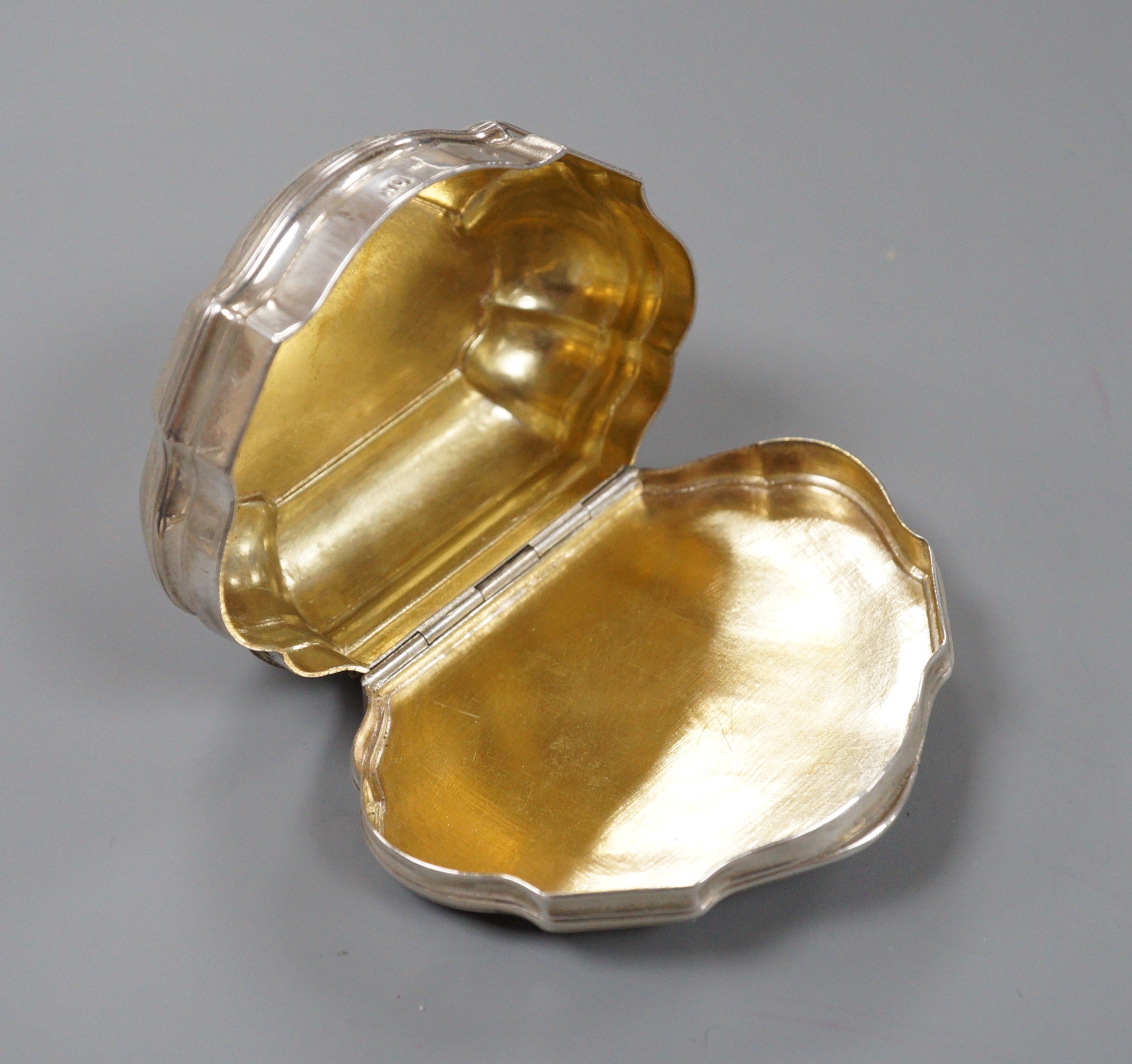 A late 18th/early 19th century white metal shaped demi-lune snuff box, makers mark, OR, 7cm, 69.5 grams.